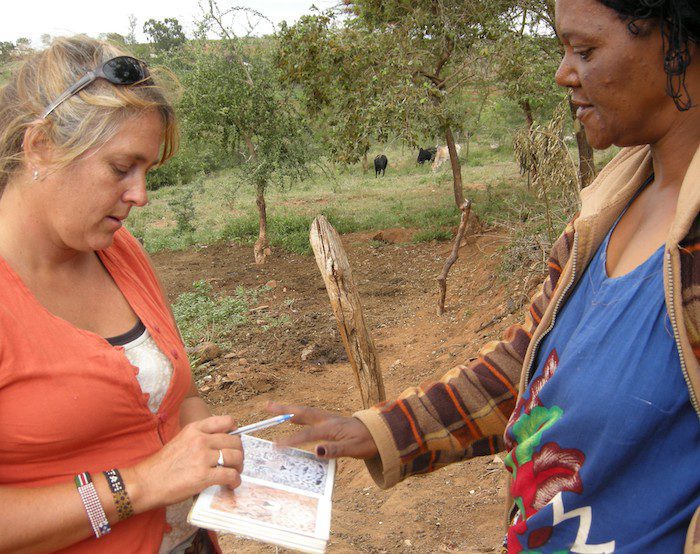 Mary talking about cheetah and leopard with a farmer after a livestock attack
