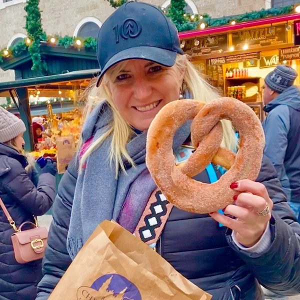 Woman holding large pretzel at Salzburg Christmas market