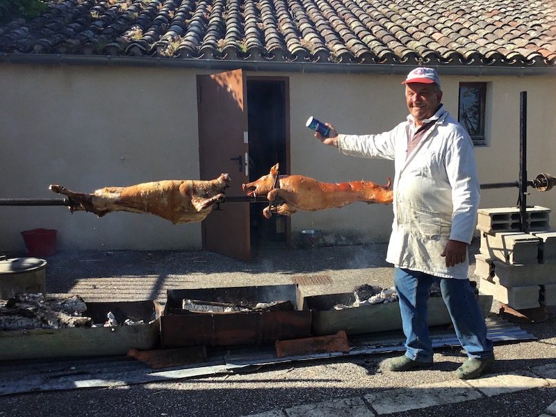 A man Roasting pigs in Castelnau-de-Montmiral, France