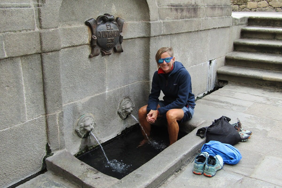 Jules Torti resting her feet in a wash basin along the Camino de Santiago