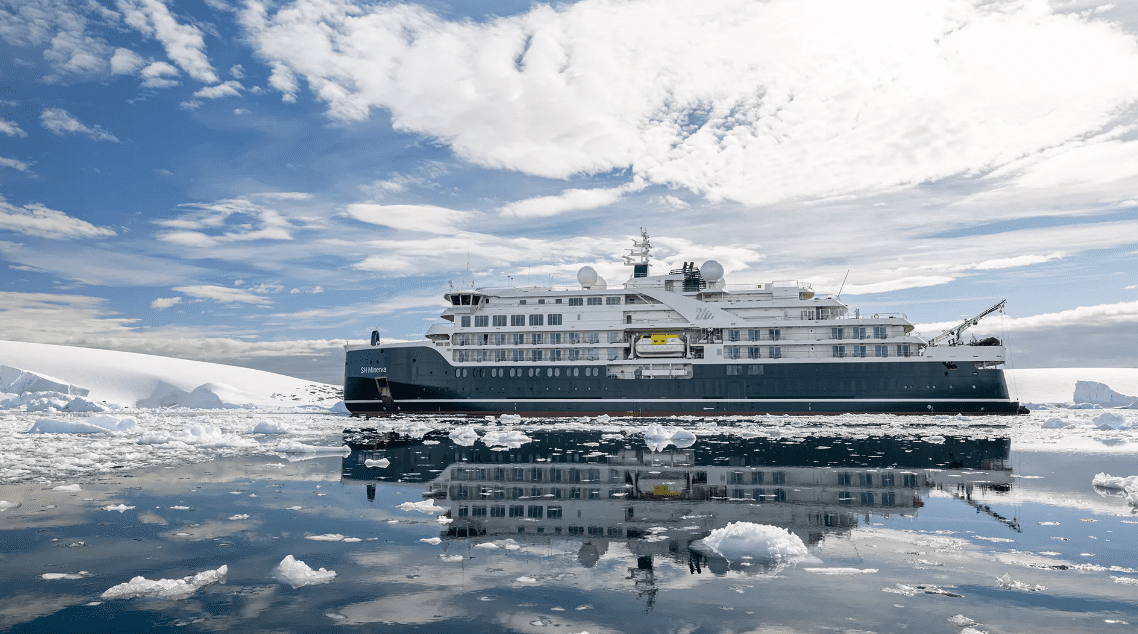big luxury cruise ship in the middle of the antarctic ocean