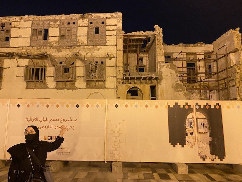 Female guide in historic Yanbu in front of the home of T.E. Lawrence ("Lawrence of Arabia"), which is being restored in anticipation of more tourism