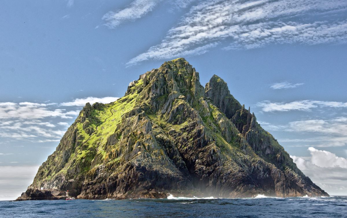 Big green rocky island in the middle of the ocean