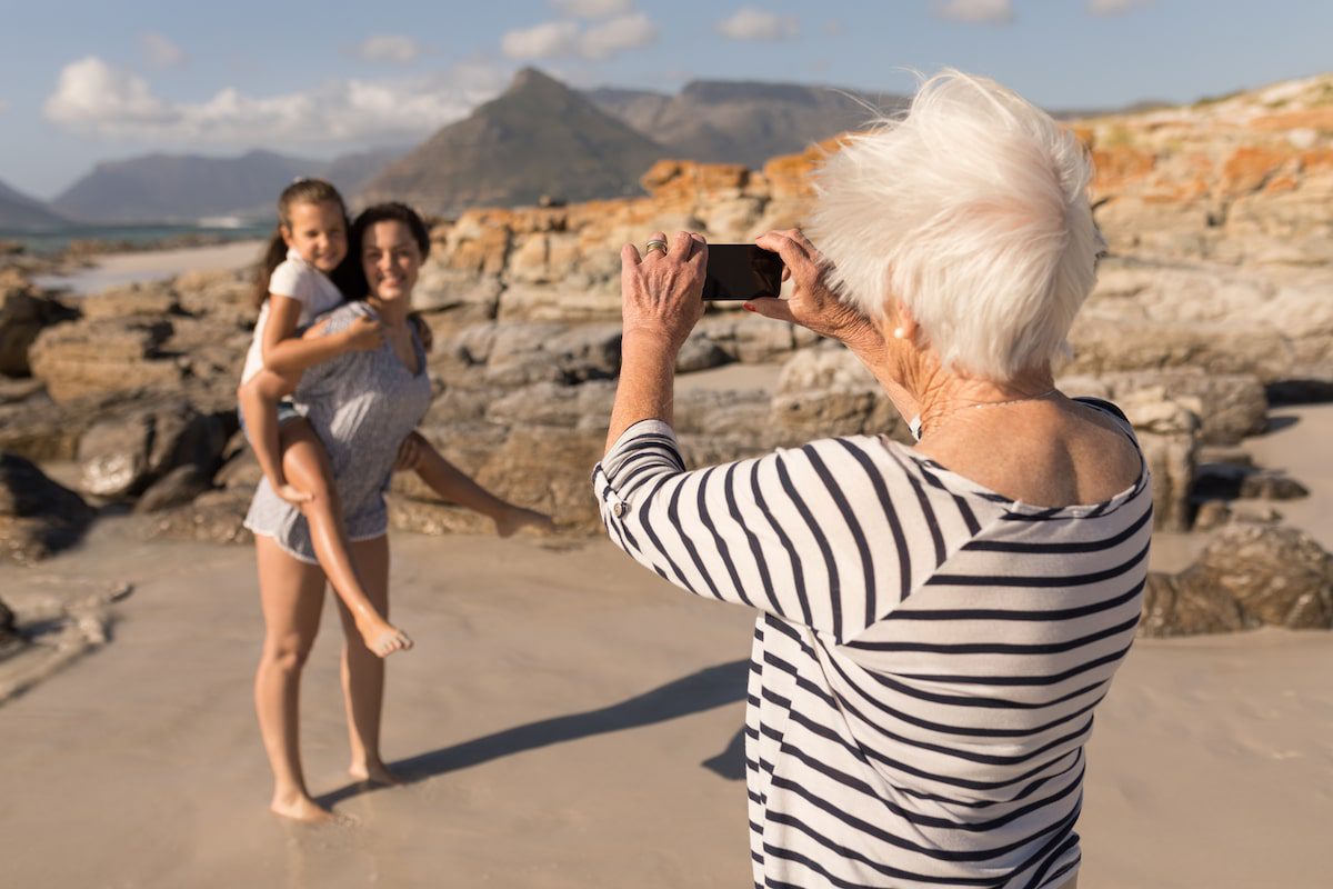A grandmother takes a photo of her daughter and grandchild on vacation, learning the etiquette of social media for grandparents.