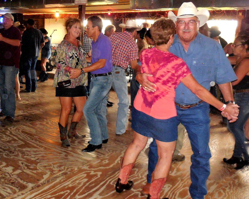 People dancing in pairs at a live music venue in Western Louisiana