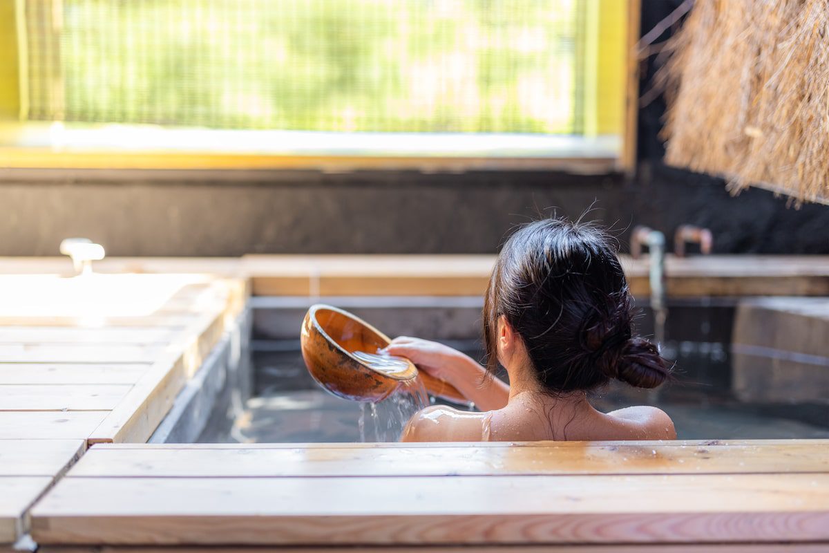 Woman enjoys the onsen in bathtub at resort in Japan