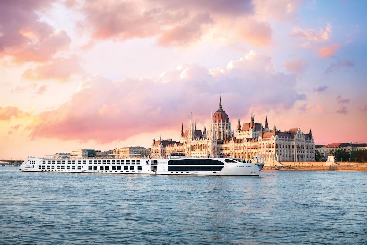 A ship part of Uniworld River Cruises sails through Budapest