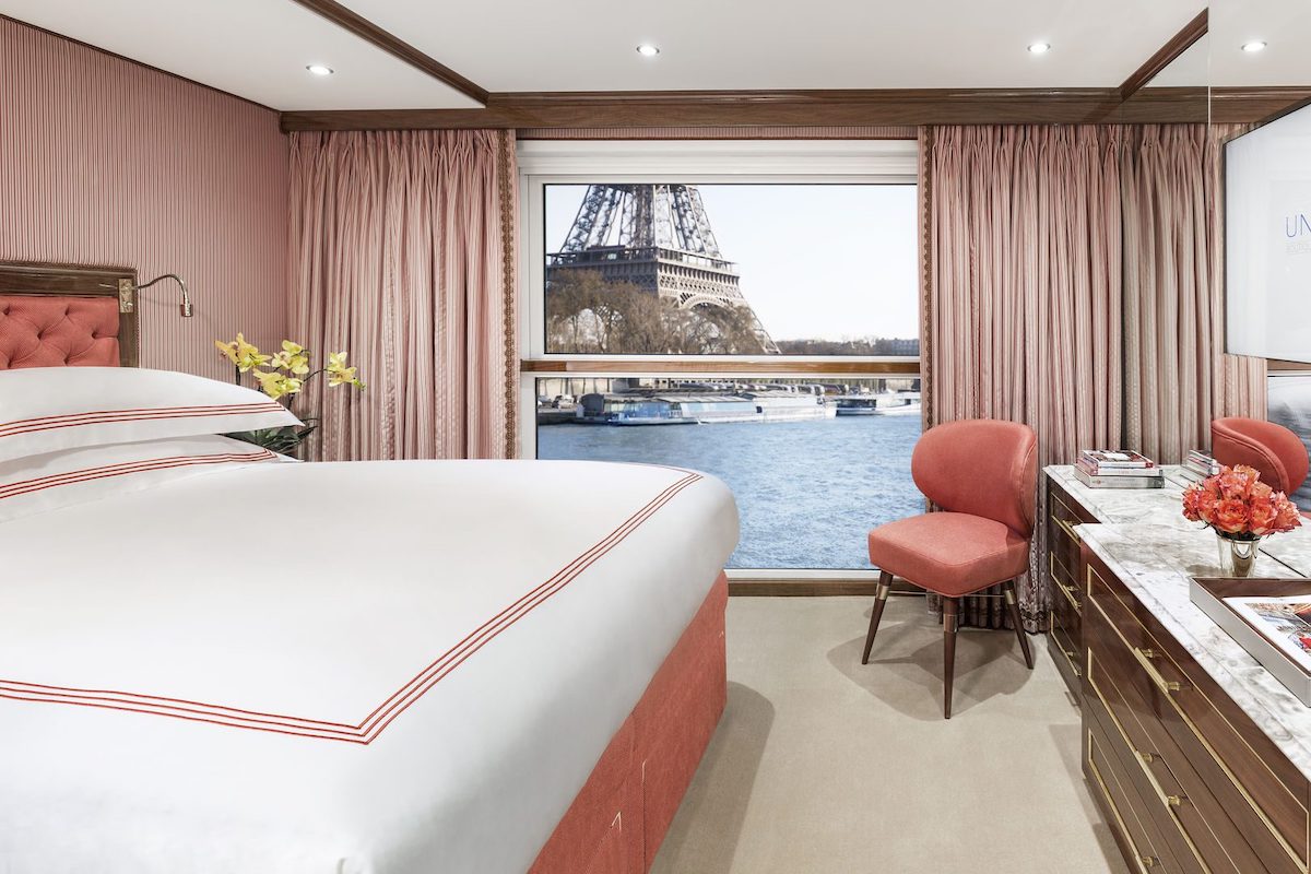 A luxurious room aboard a Uniworld River Cruise with the Eiffel Tower visible through the window