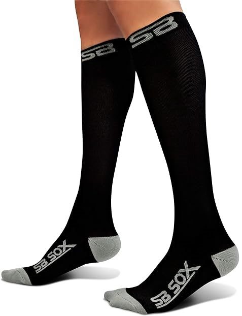 two legs wearing knee high black socks