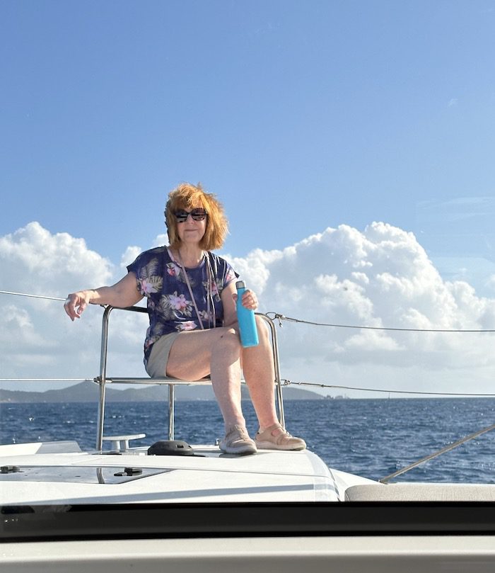 Diana Eden sits on the catamaran on a sailing for seniors trip