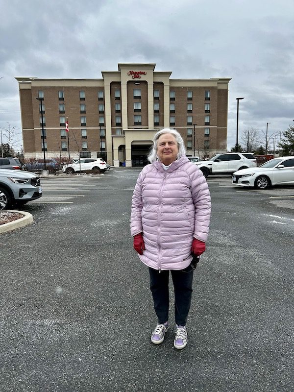 Heather stands in front of a hotel in Ottawa, Canada, during her first trip as a widow.