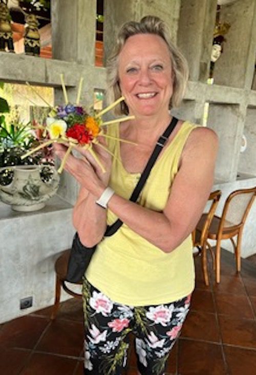 Nancy Smith holding a traditional offering in Bali