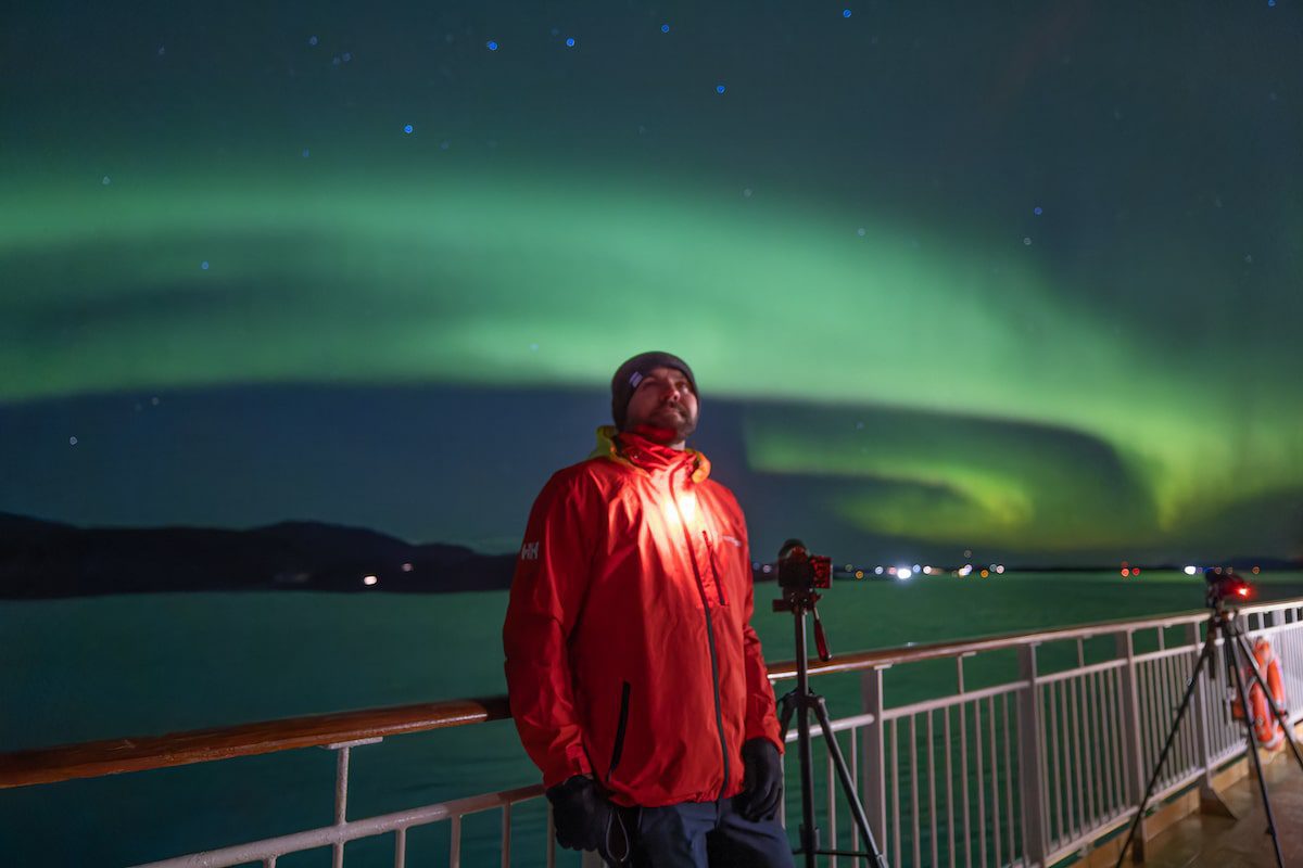 Tom Kerss, Hurtigruten, in front of the Northern Lights in Norwar