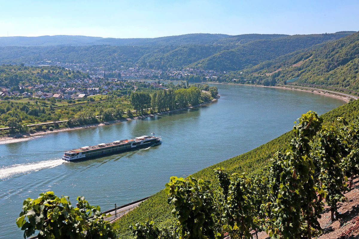 Avalon Artistry II sailing on the Rhine River, flanked by lush vineyards and the rolling hills of Germany