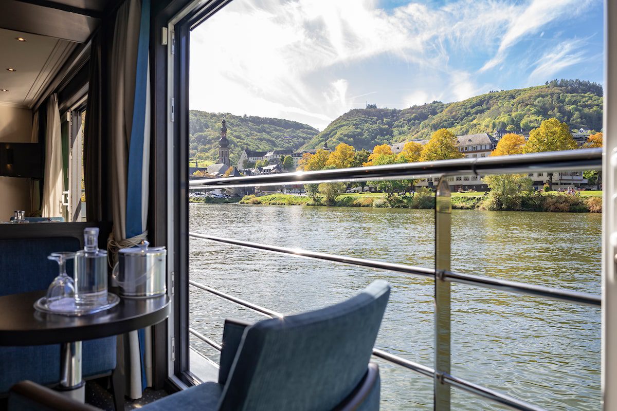 Panorama Suite view - framing an inviting view of the tranquil river and lush riverbanks beyond on an Avalon river cruise