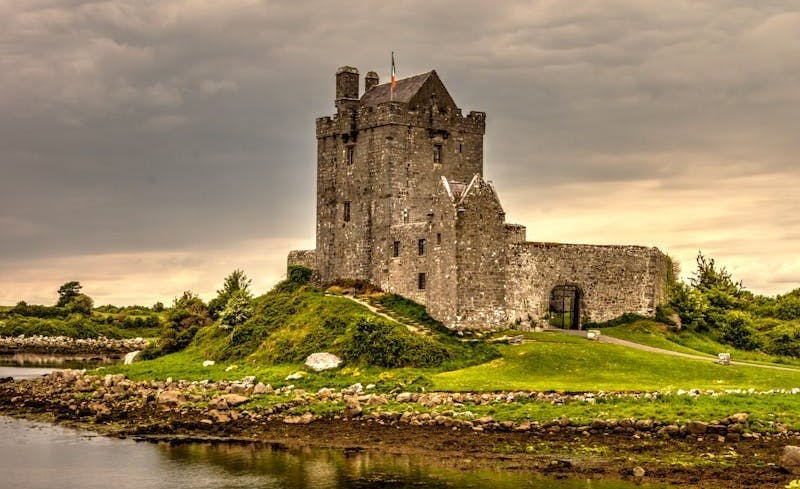 image of an old scottish castle standing on a green mound of grass in scotland
