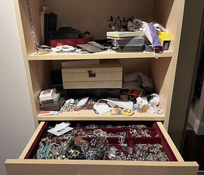 Disorganized jewelry box before being tidied