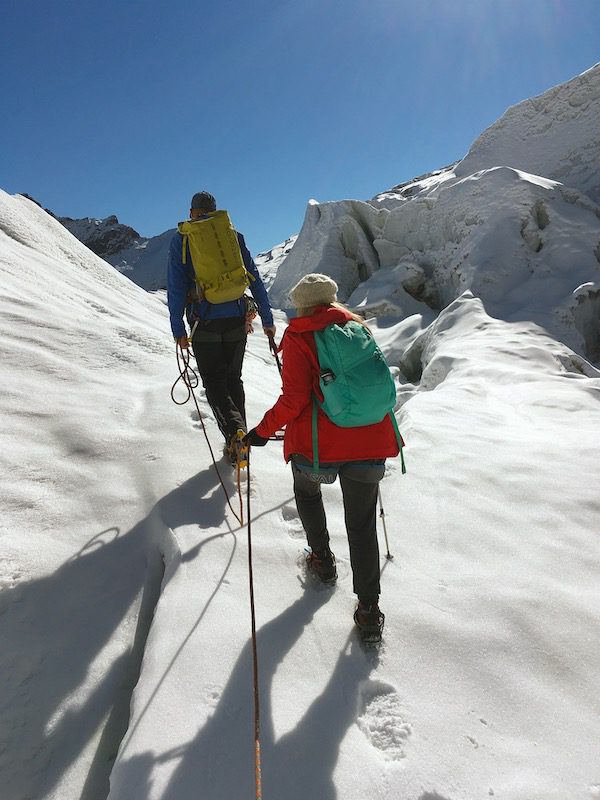 Two people hiking up a Swiss Glacier