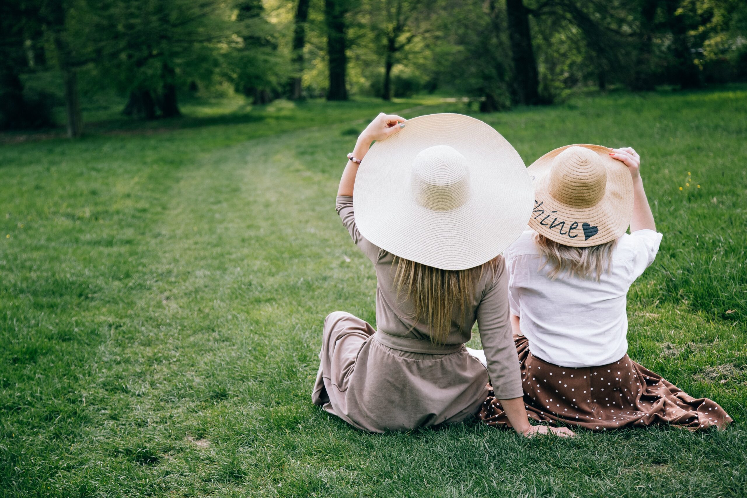 two women sitting on the grass mother daughter