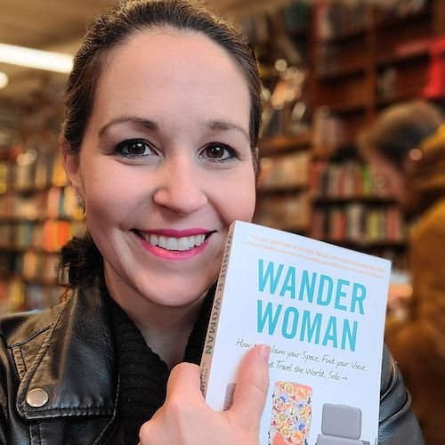 Beth Santos holding her new book Wander Woman