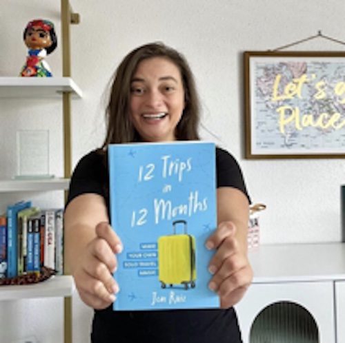 Jen Ruiz with her book 12 Trips in 12 Months