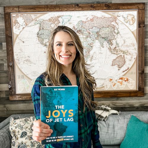 Kat Medina holds a copy of her book, Joys of Jet Lag Photo