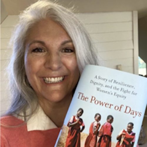 Celeste Mergens holding a copy of her book, The Power of Days