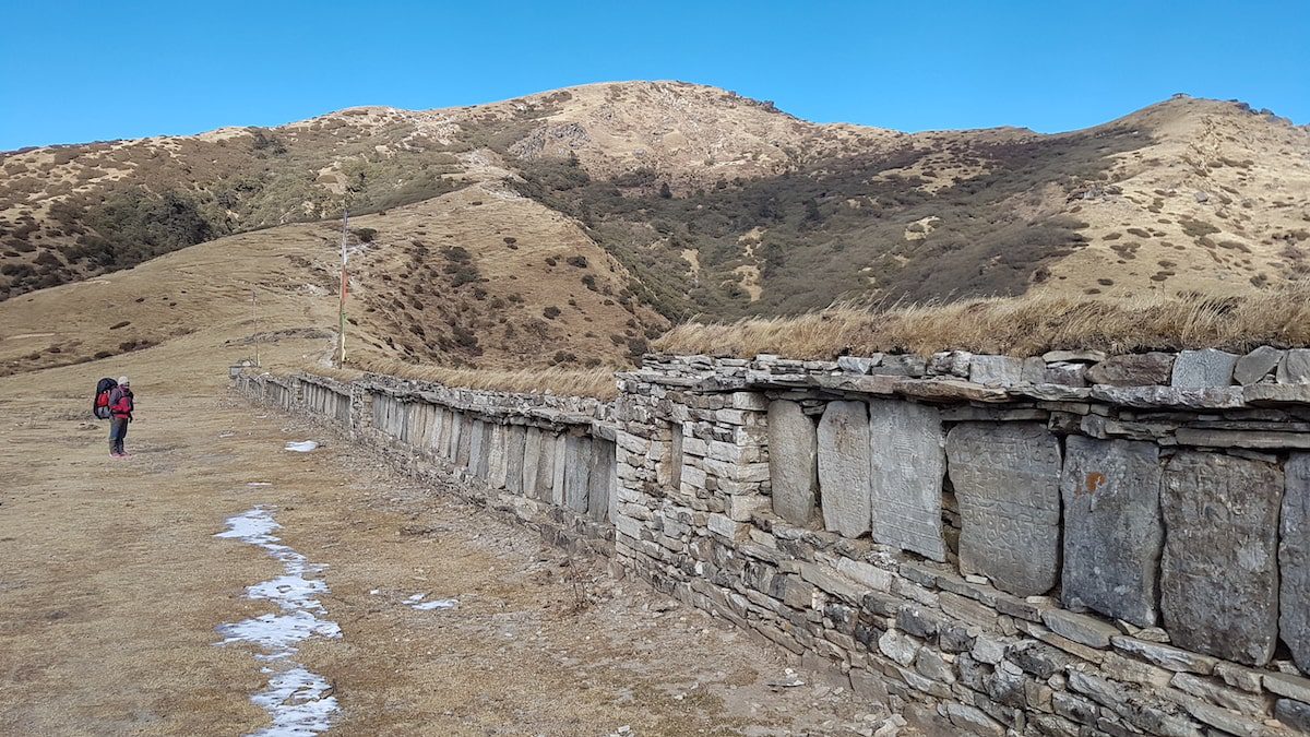 A long stone mani wall along the Himalayas