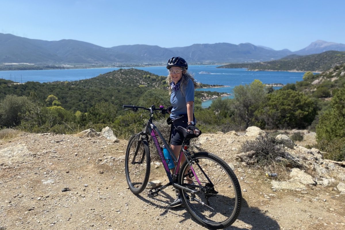 Diana Ballon with her bike on a cycling trip in Greece. Diana suggests cycling as active travel for women over 50.