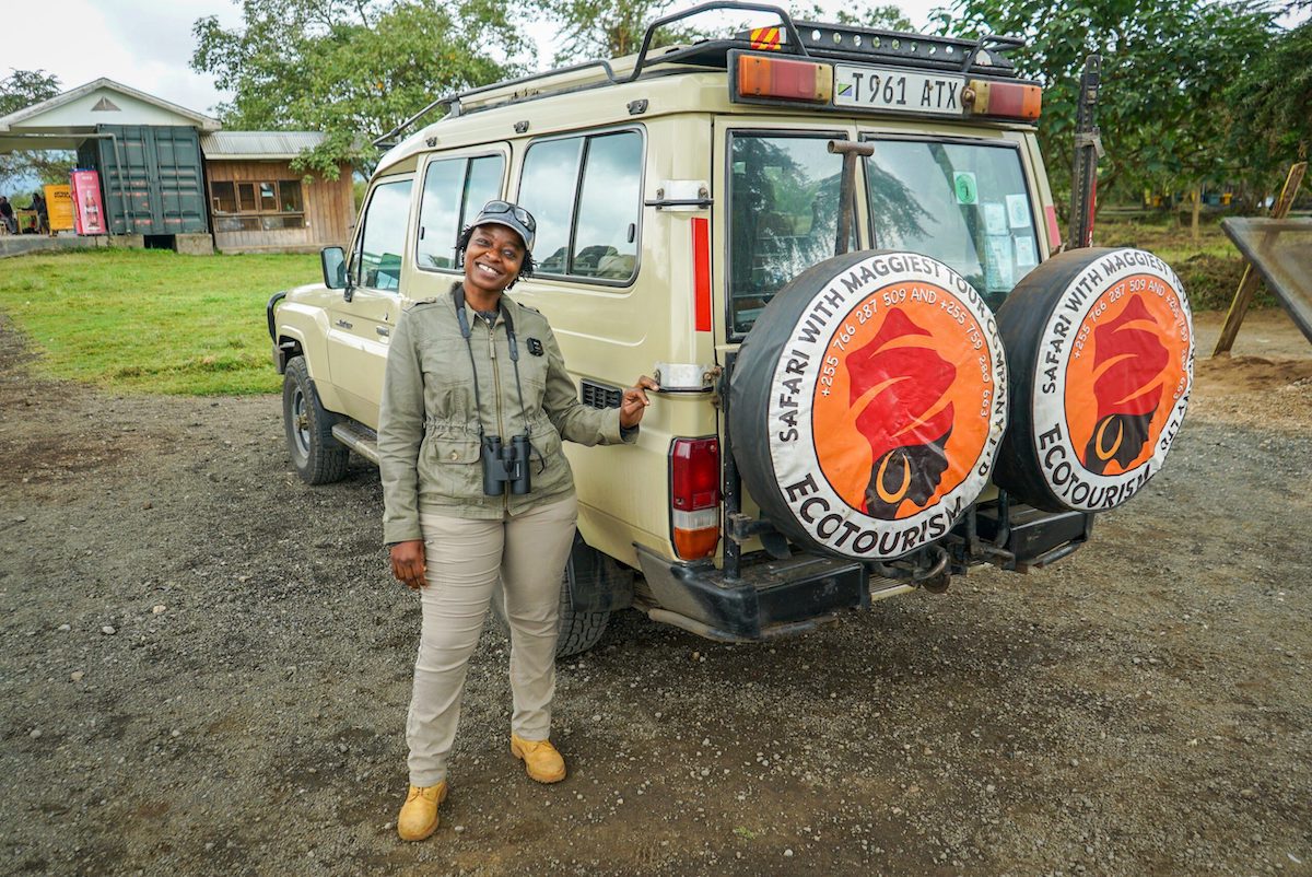 Maggie Duncan Simbeye of Maggie's Tour Company standing in front of a safari truck