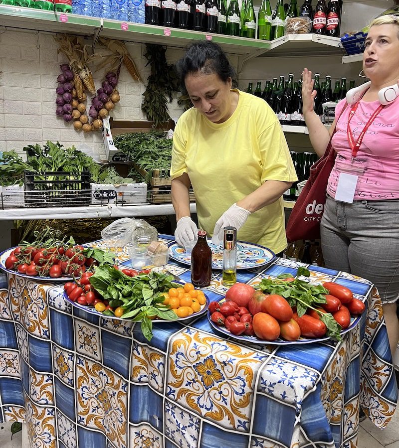 Tina the shop owner in her produce shop in Naples, Italy