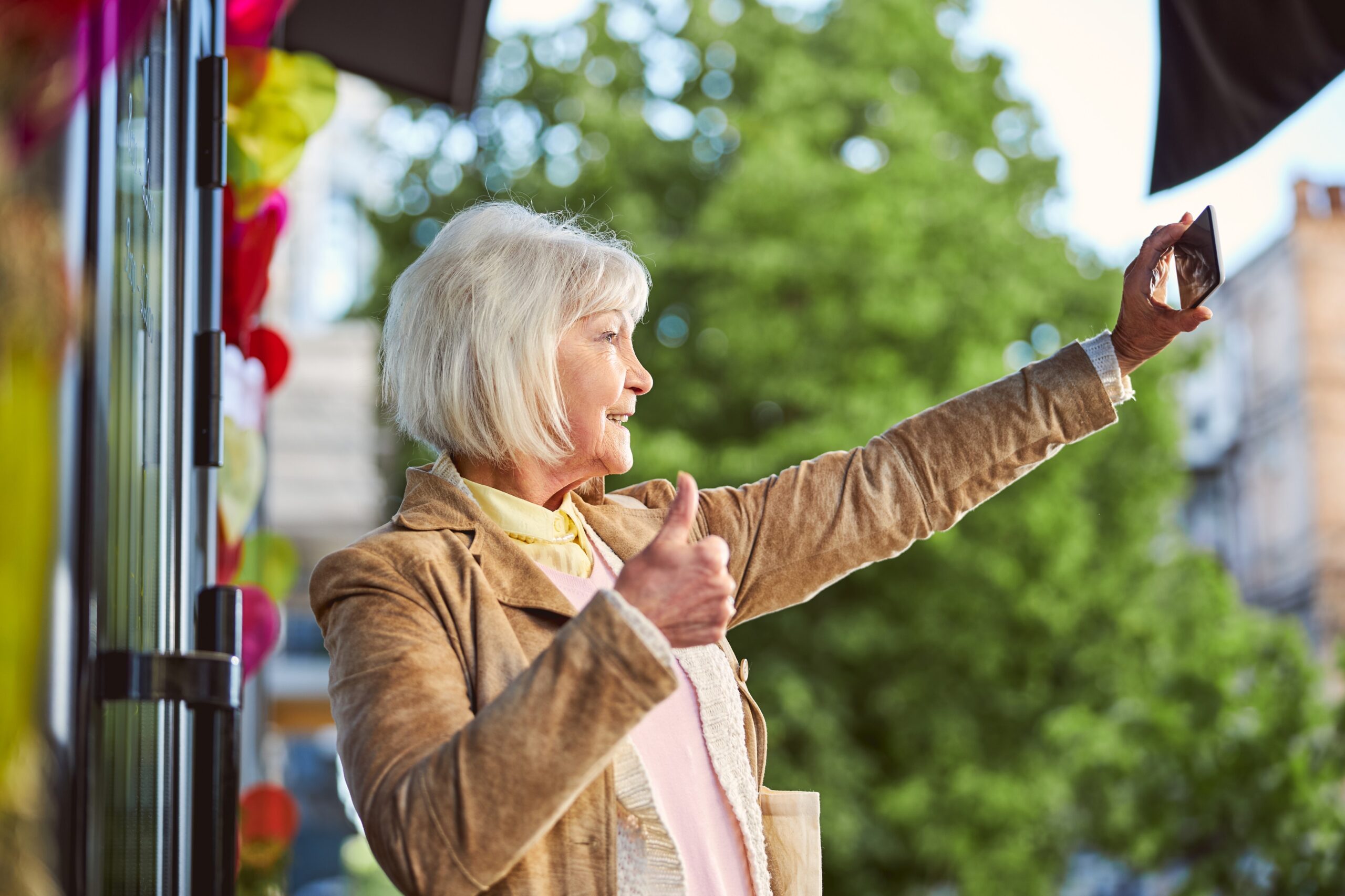 post menopausal woman grandmother waving to her grandchildren while travelling