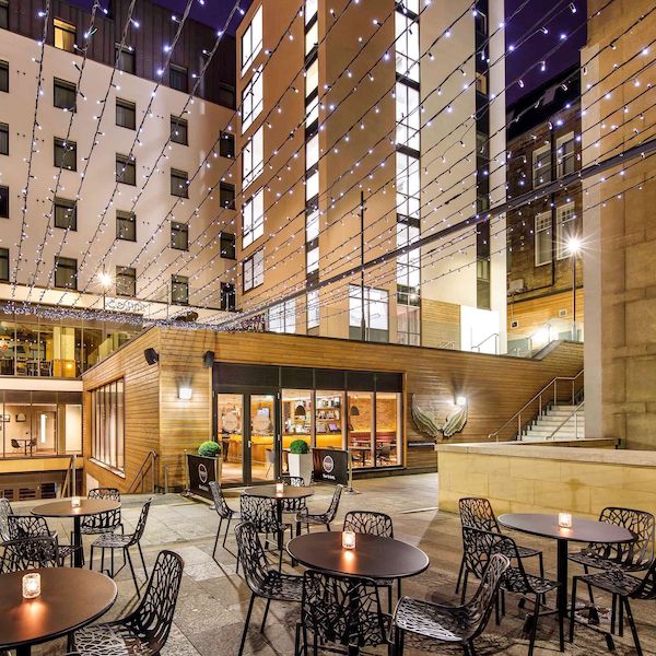 Patio lit with string lights at the ibis Edinburgh Centre South Bridge