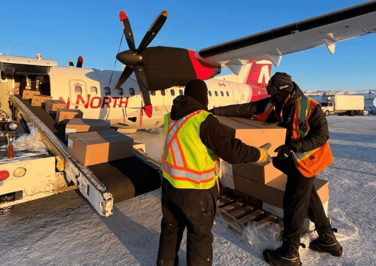 Canadian North crew and plane loading a plane