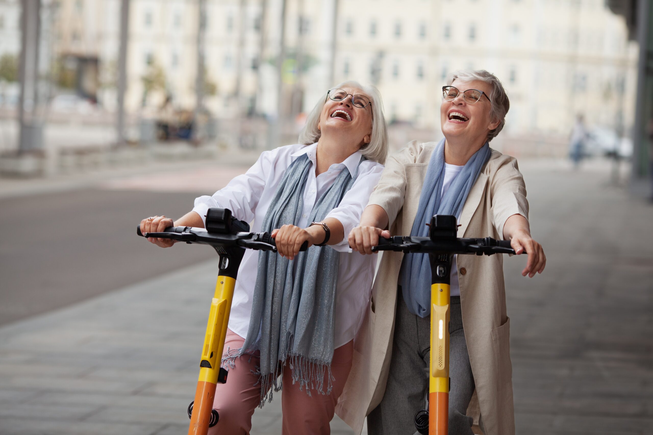 two women riding scooters By annazzhuk