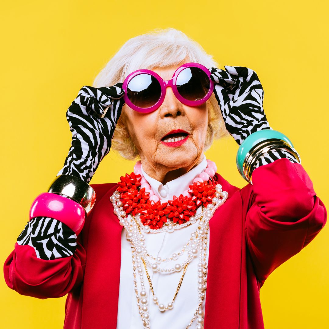 An older women wearing colourful sunglasses and accessories