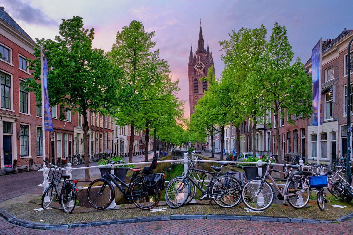 Bikes line a railing of a canal in Delft the Netherlands