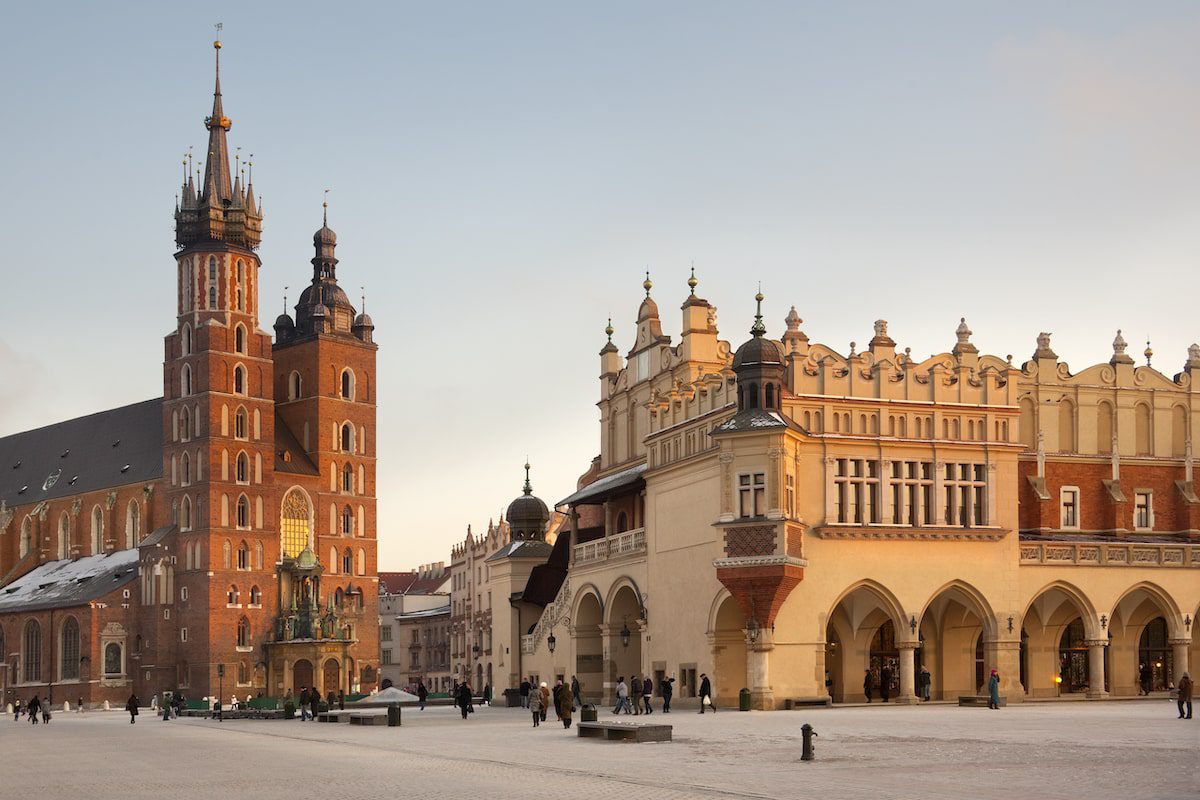 Church of St. Mary and the Cloth Hall in the main Market Square (Rynek Glowny) in the city of Krakow in Poland.