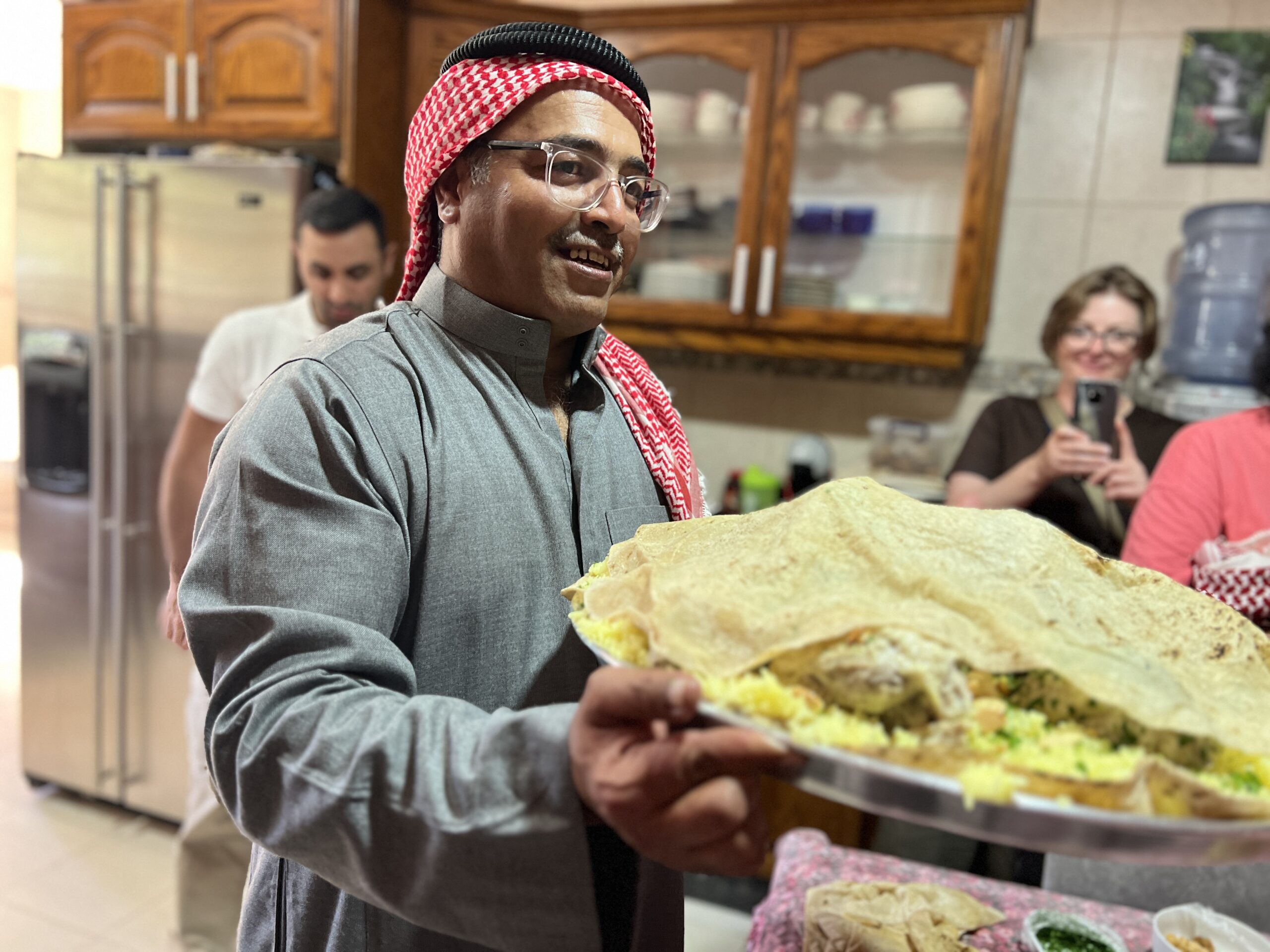 woman holding a tray of food in petra jordan 