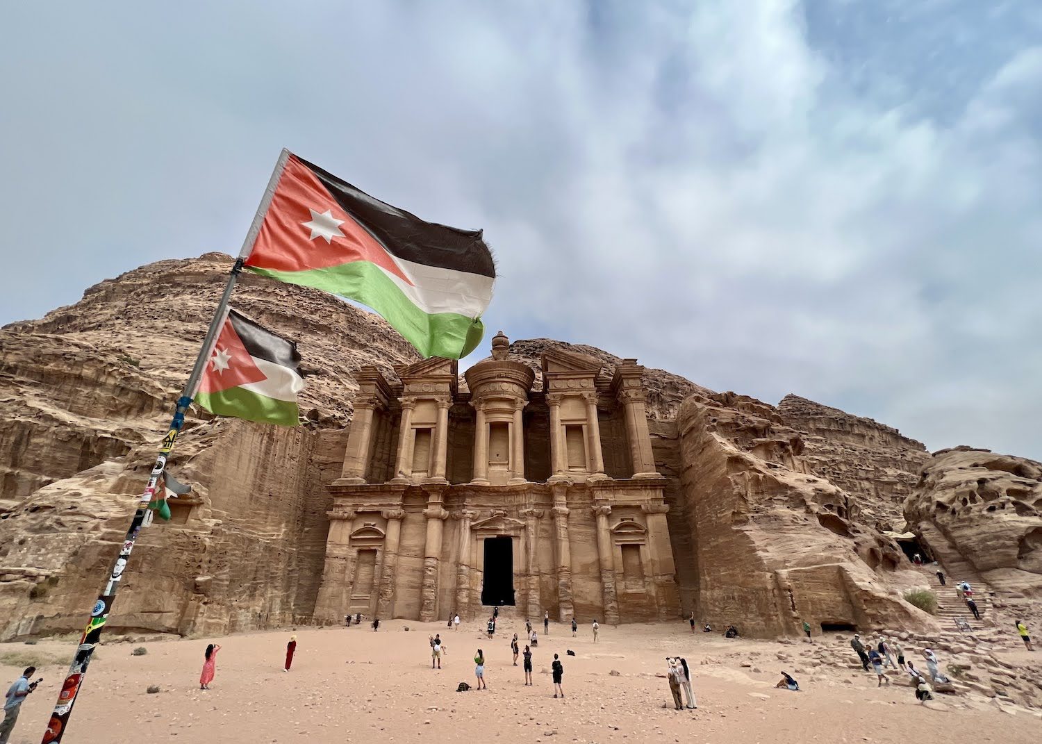 petra monastery and jordan flag Bain