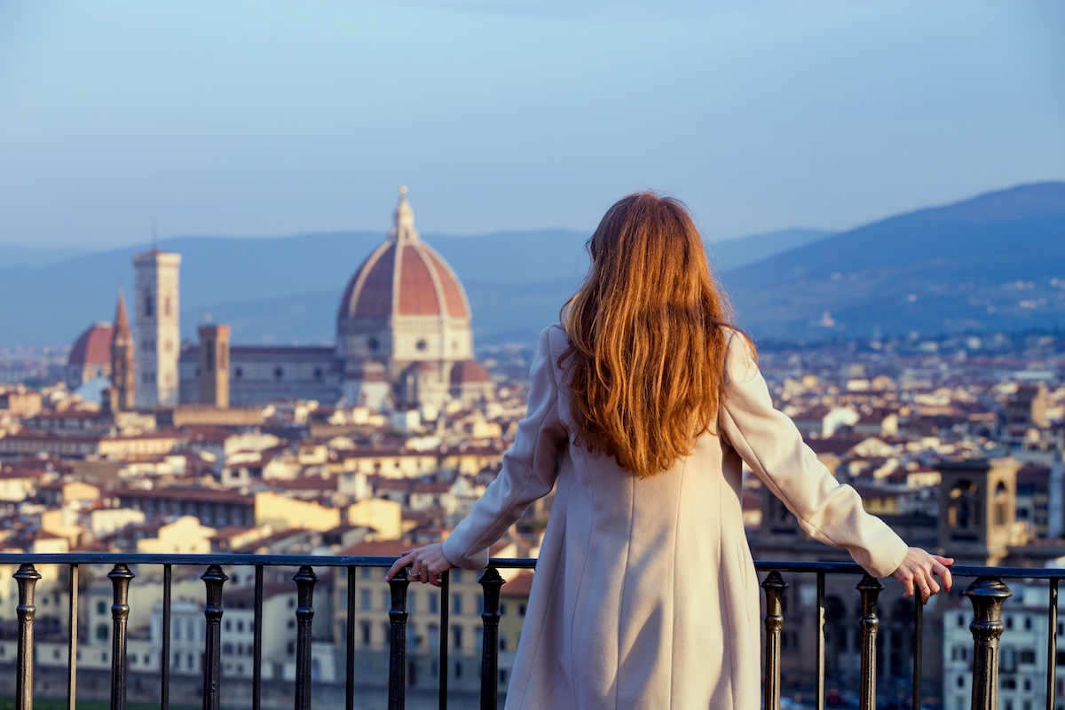 Woman looking at the city of Florence from the viewpoint