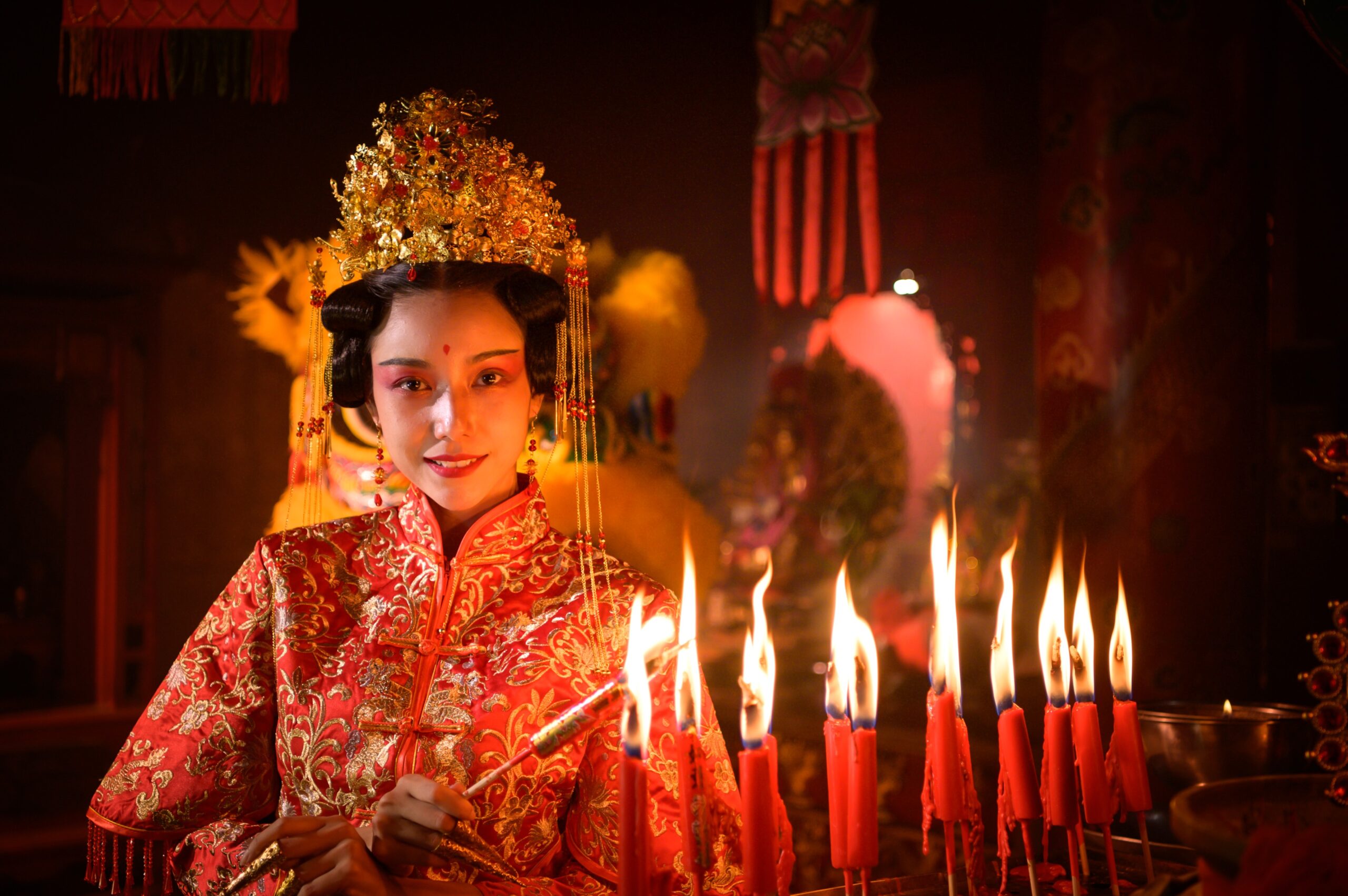 woman lighting candles for chinese new year festival