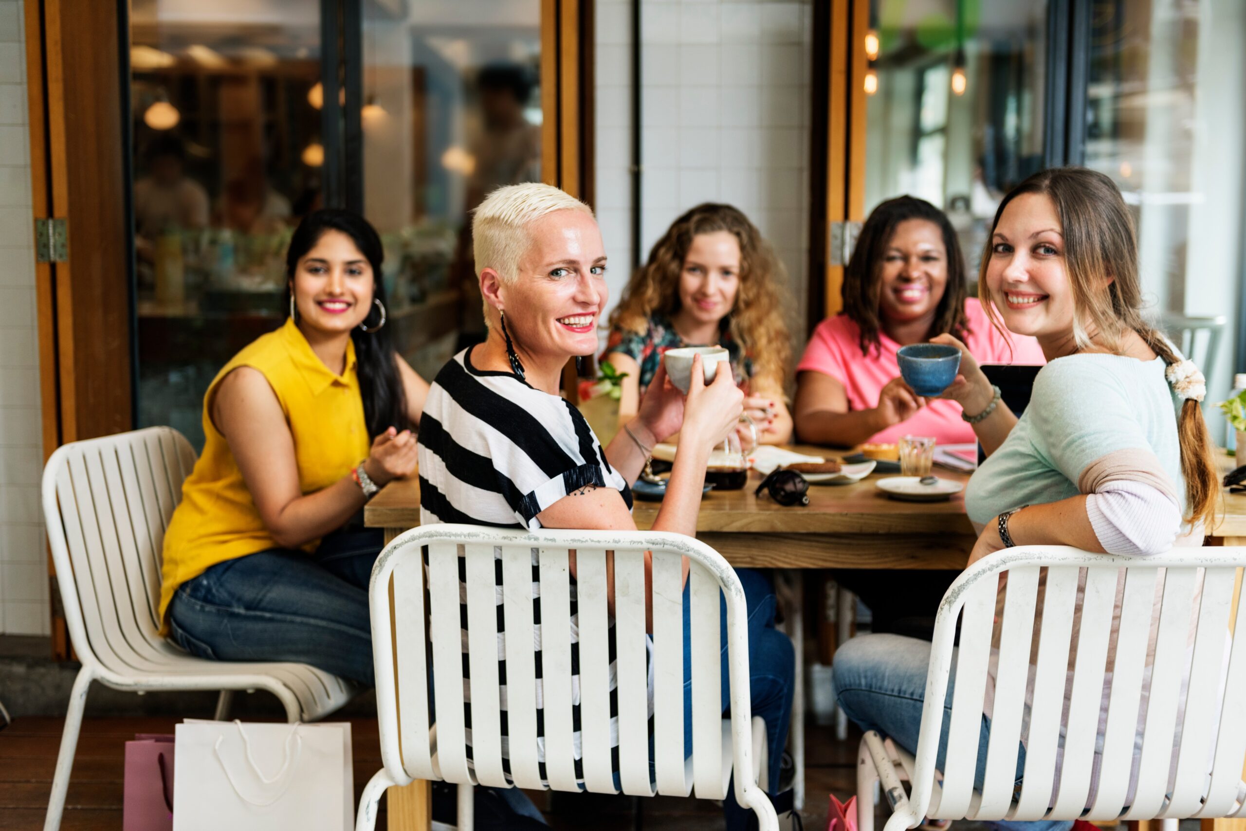 diverse women in a cafe creating community