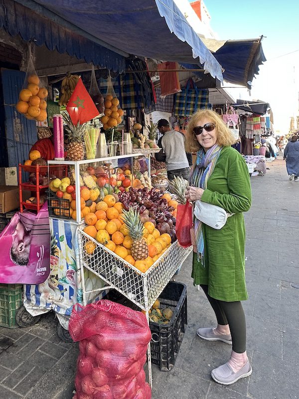 Diana Eden ay a fruit market in Essaouira, Morocco