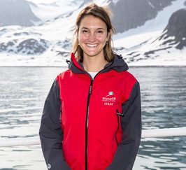 woman smiling in red jacket aurora expeditions 