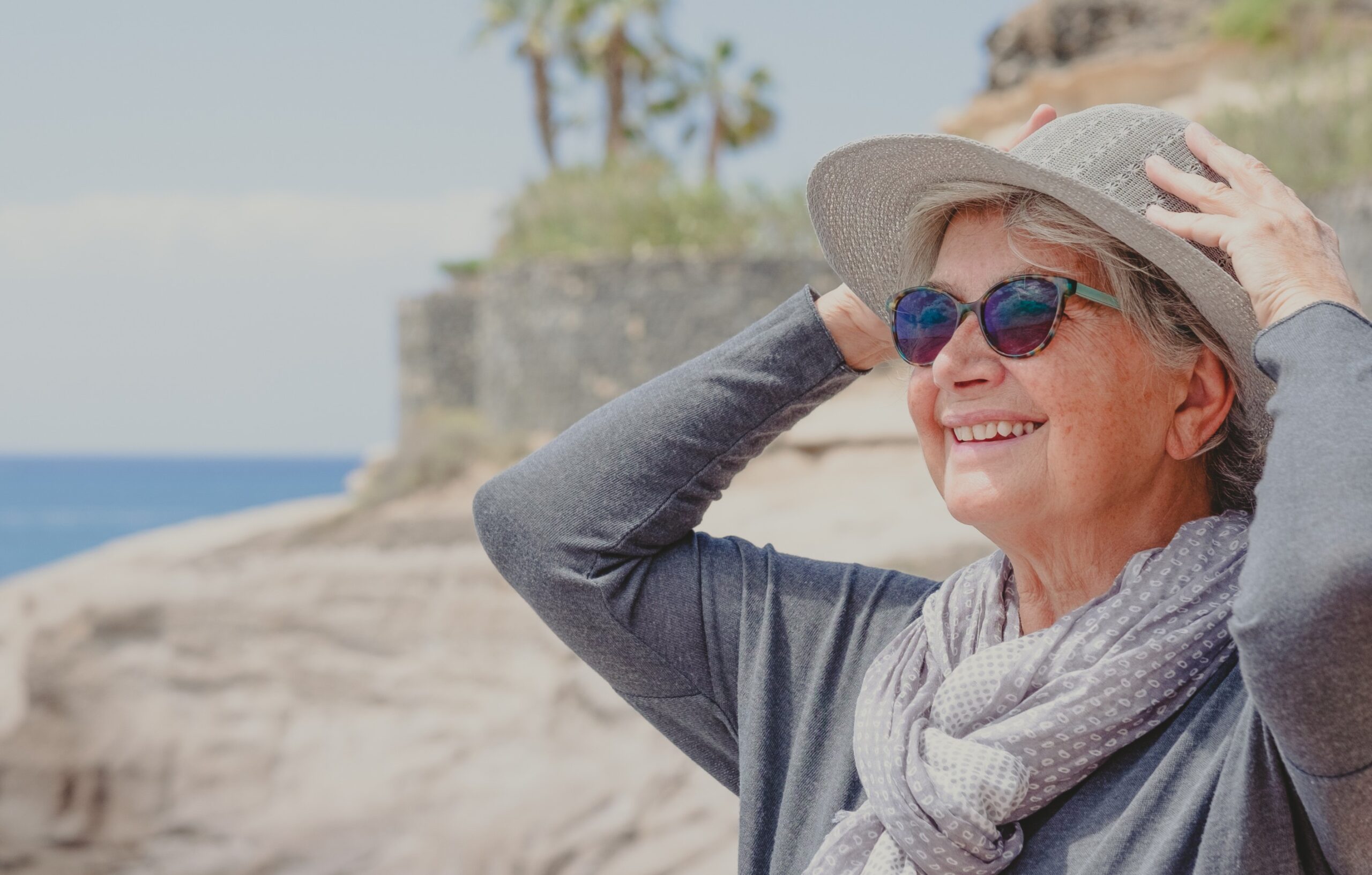 older solo woman traveller looking into the wind