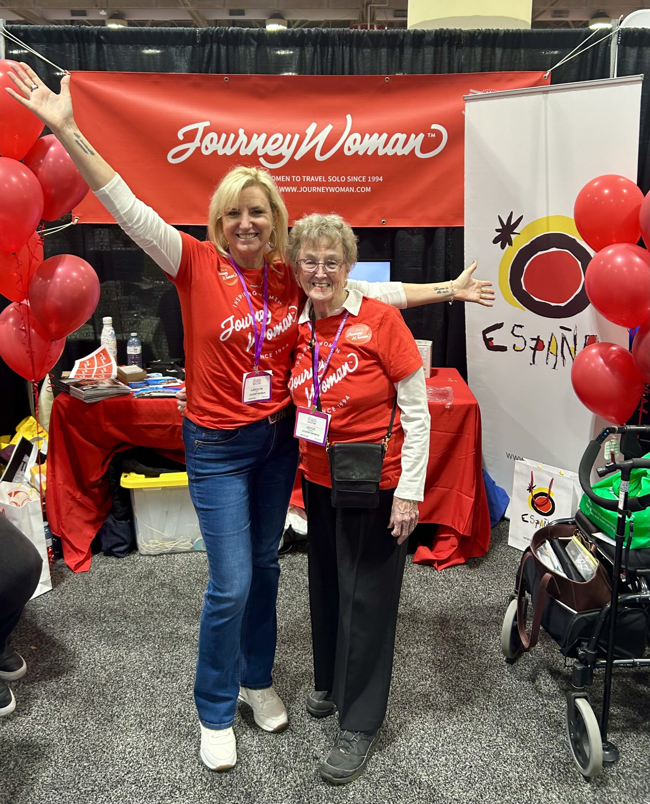 two women standing in red journeywoman shirts