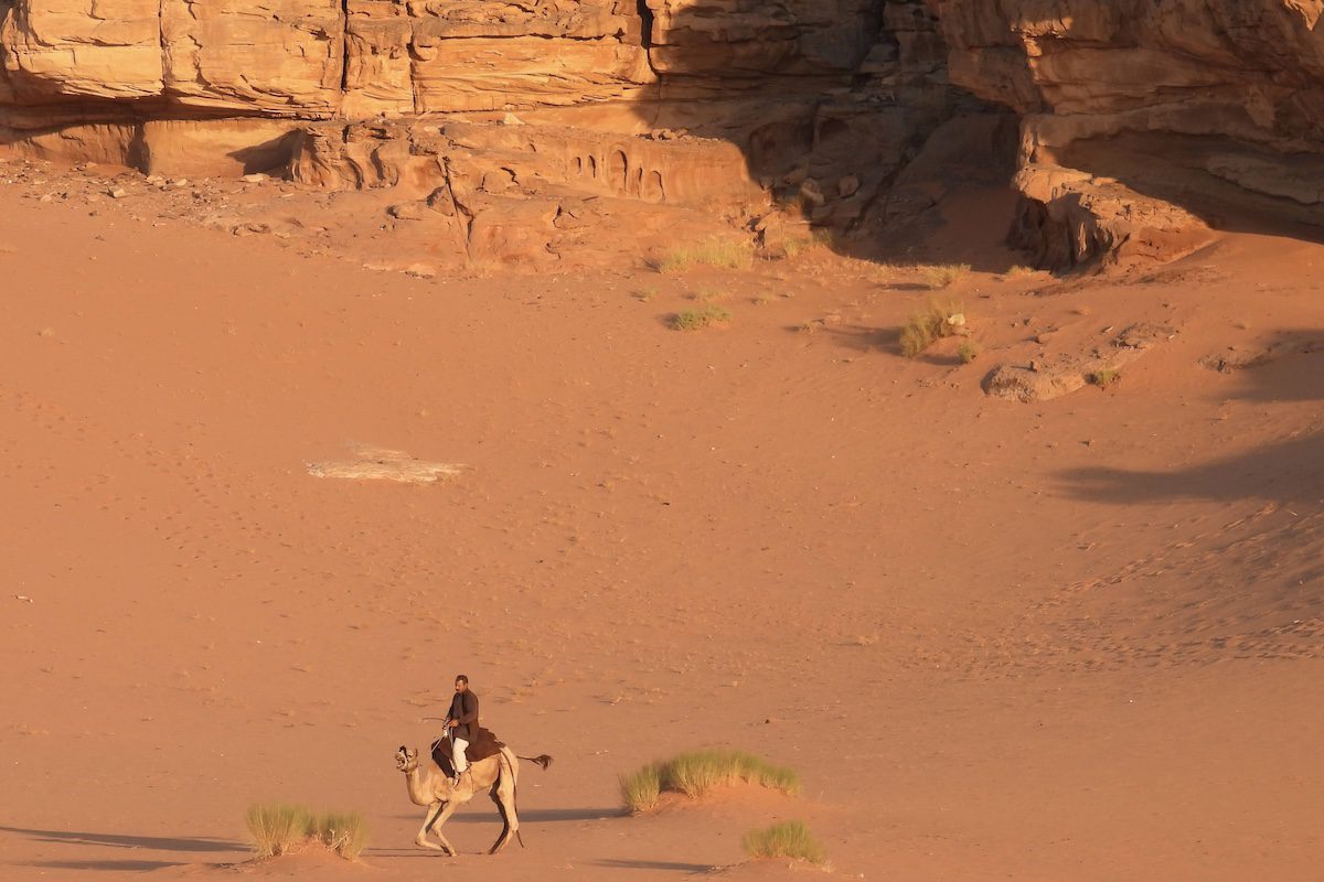 A Bedouin and his camel in Wadi Rum, Jordan's red desert