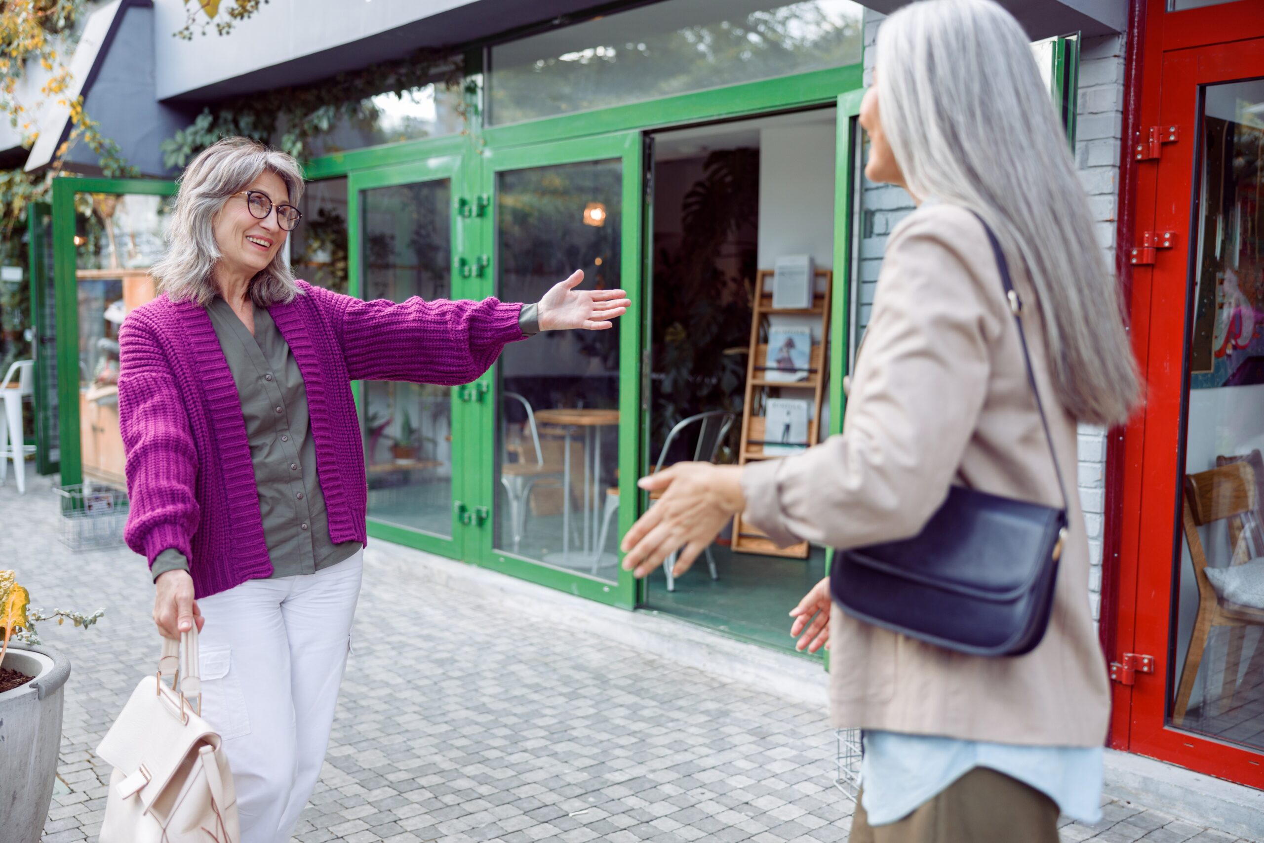 happy senior women meeting on the street