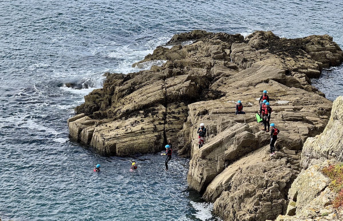 Coasteering is a Welsh-invented pastime which has participants leaping into the ocean after scrambling up the steep shoreline.